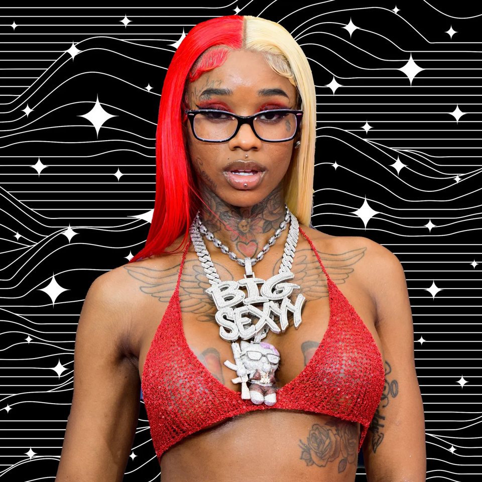 Sexyy Red in red braids and glasses wearing a Big Sexyy chain