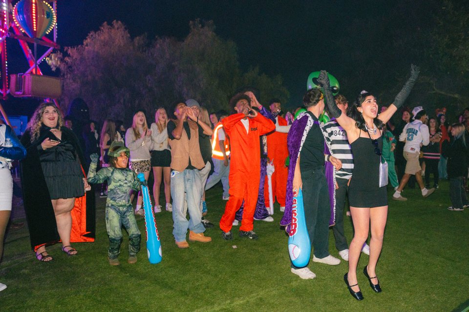 Guests in costume cheering on the SKVLKFest lawn